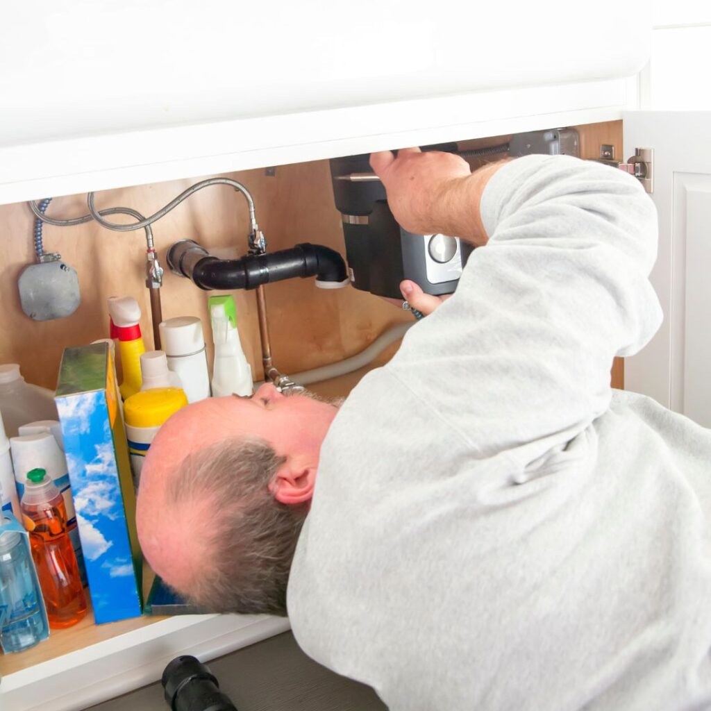 plumber installing garbage disposal