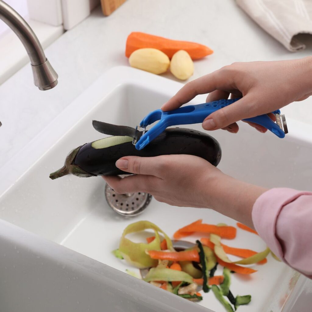 peeling vegetables over sink