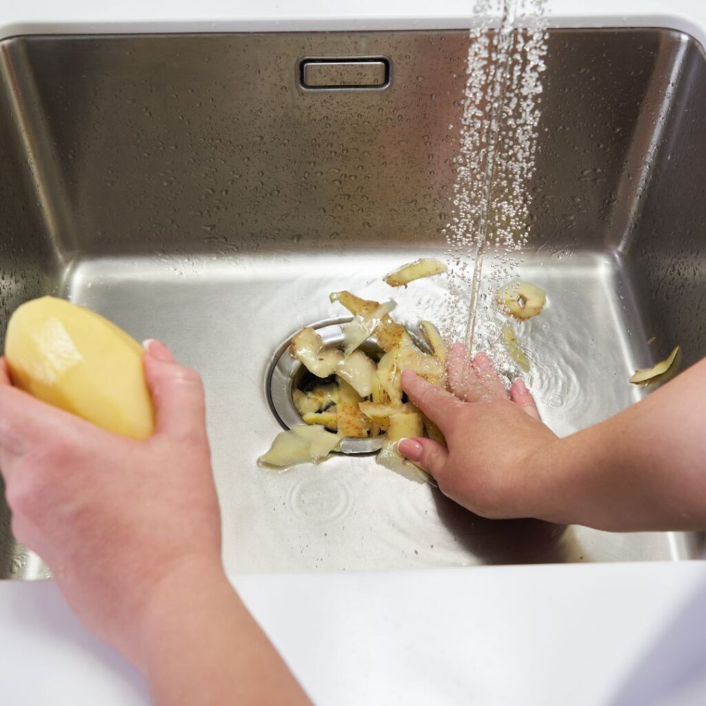 putting potato peels down kitchen sink