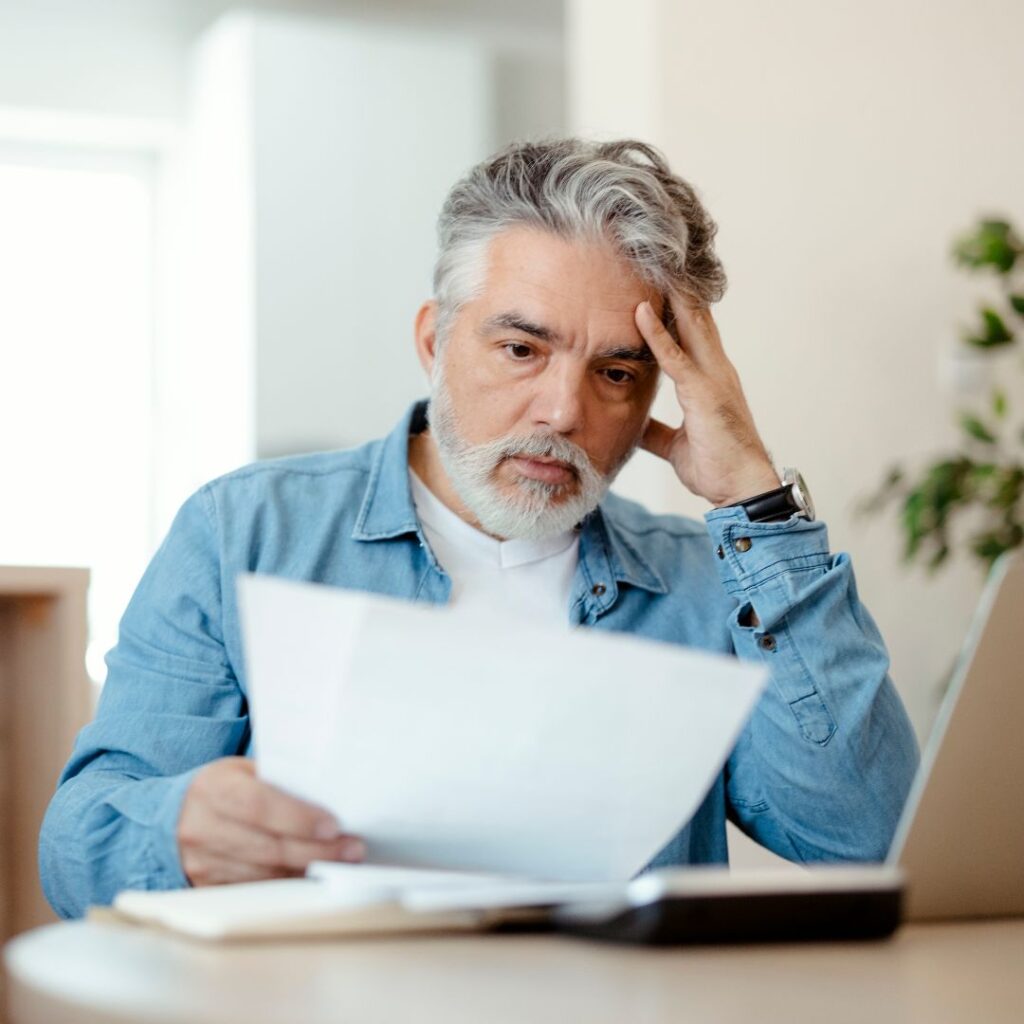 man looking over a bill