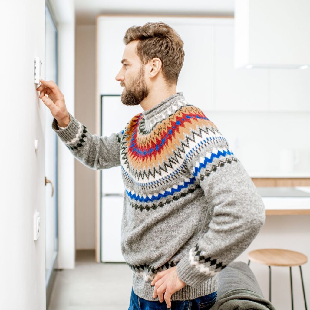 man adjusting temperature